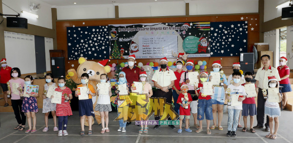 和谐圣诞填色比赛获得三大种族孩子参与，图示得奖者在领奖后与嘉宾一起分享喜悦。