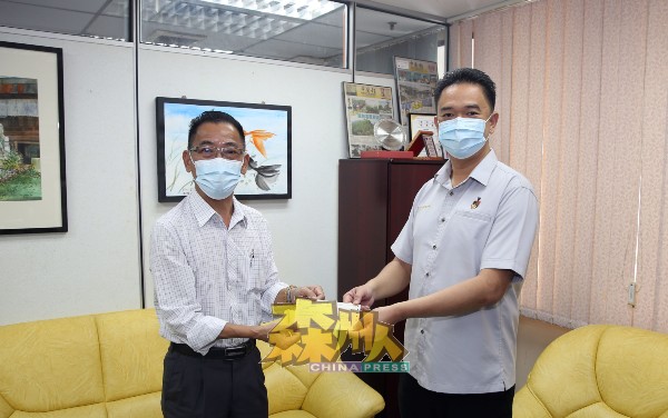 张聒翔（右）代表州政府移交6万令吉支票予梁福源，作为赞助全森82间华小《中国报》森州“小学生阅报计划”用途。