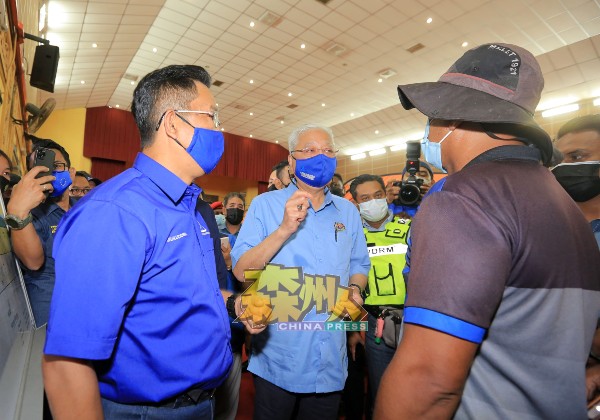 首相依斯迈沙比里（左2）巡视格拉旺临时疏散中心时，灾黎向首相反映他们面对的问题，左为嘉拉鲁丁。