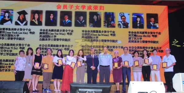 会员子女学成归来，获得会馆颁发纪念品庆贺，右7起为陈金庭、颜志波。