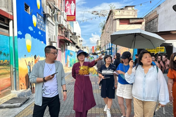 陈丽群（左2）化身导游，带领东北旅游考察团到访芙蓉市区的艺术巷。